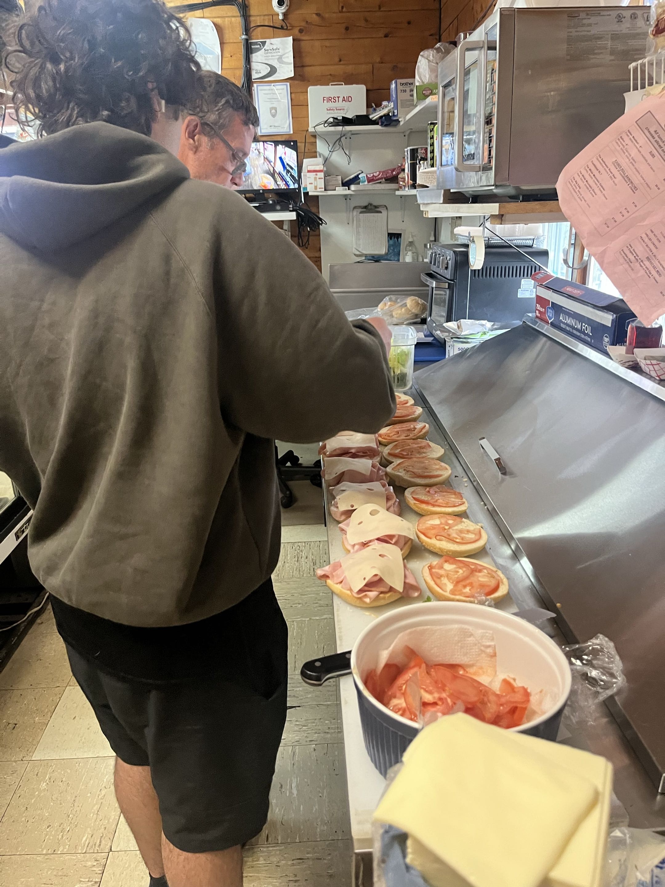 Making fresh subs behind the counter